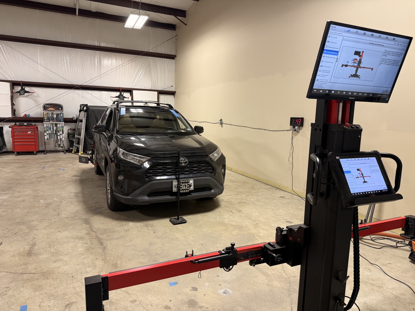 Toyota RAV4 set up on the ADAS calibration rig with a target board and dual monitors after a windshield replacement at South Texas Auto Glass in Corpus Christi, TX