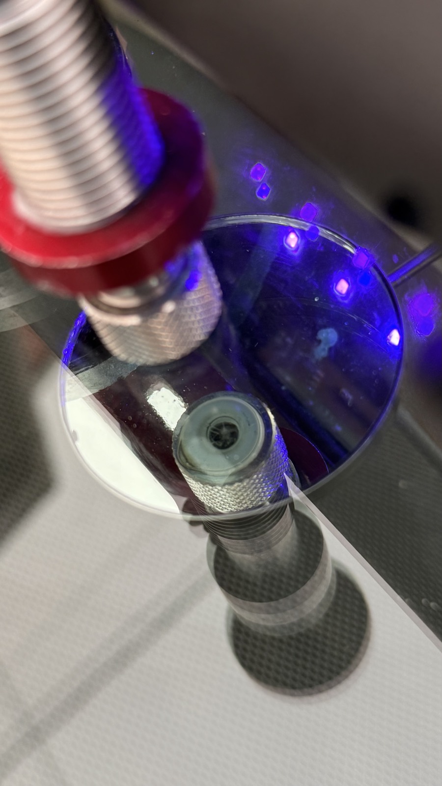 Windshield rock chip being repaired with a UV resin injector and suction-cup bridge tool under a curing light during a chip repair at South Texas Auto Glass in Corpus Christi, TX