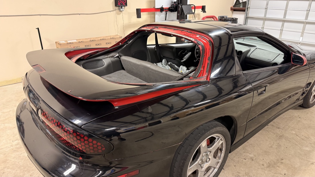 Pontiac Firebird in the South Texas Auto Glass shop in Corpus Christi, TX with its rear glass removed for a glass replacement, the kind of job we handle on any make or model, insurance or cash