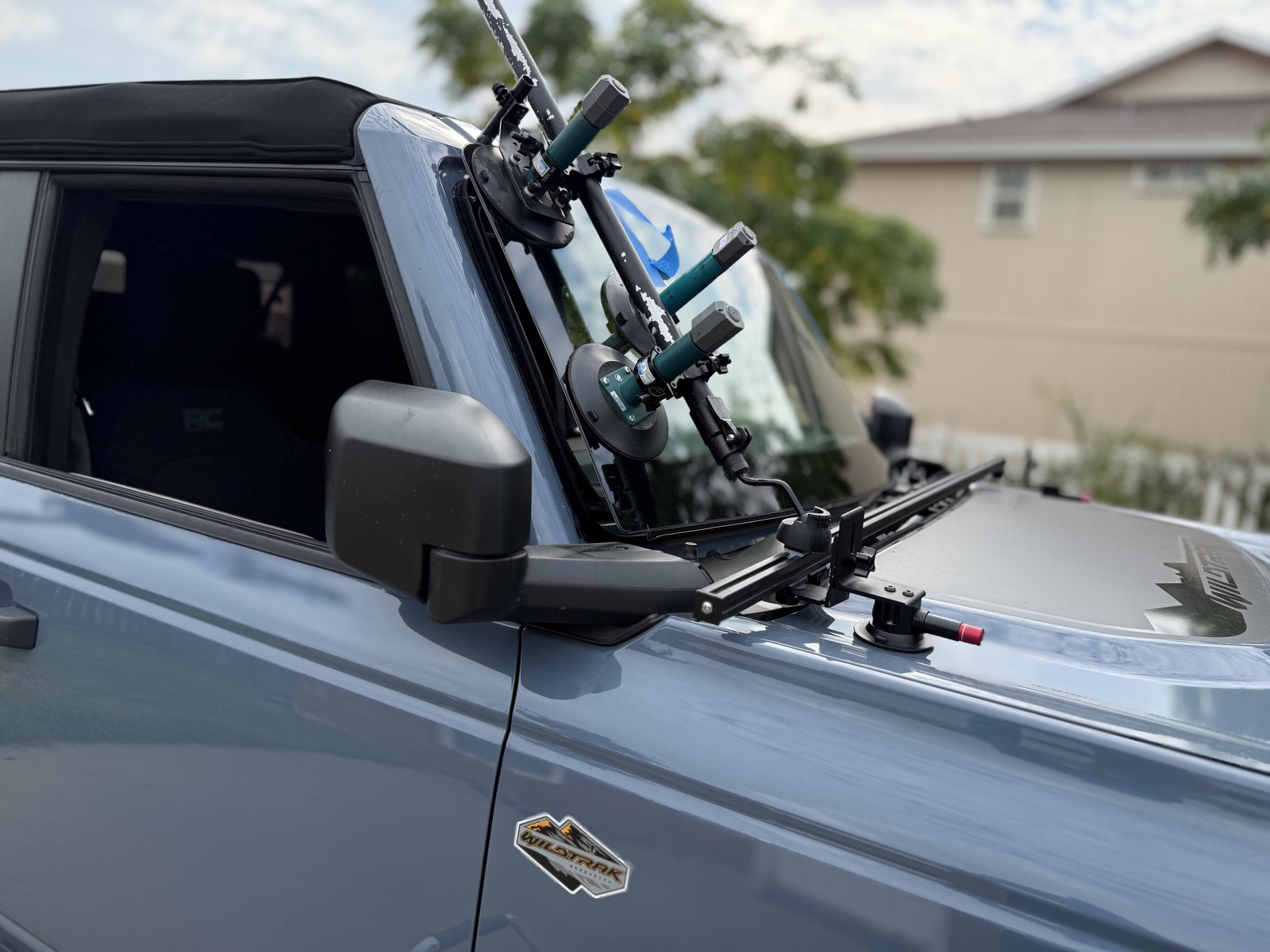 Windshield being seated on a Ford Bronco with precision glass-setting tools and vacuum cups during a mobile windshield replacement by South Texas Auto Glass in the Corpus Christi area